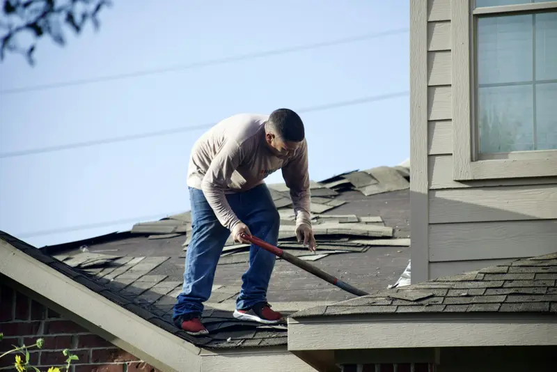 Roofer fixing shingles